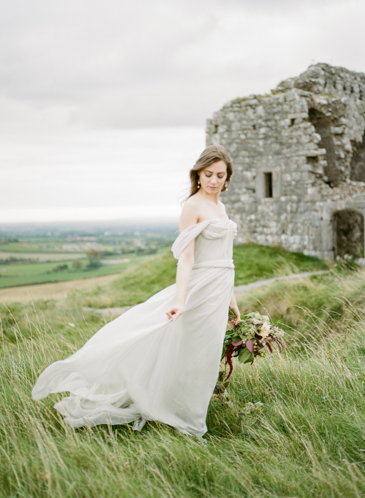 Ireland wedding inspiration photographed at a castle in County Laois by fine art wedding photographer Kayla Yestal. This elegant and refined shoot features model Paloma Feijoo of Distinct Model Management in Dublin in a grey Alexandra Grecco Thalia gown from Sash and Bustle in Toronto. Earrings by Hattitude Jewels, ring and necklace by Anouk Jewelry, and stationery from All Things Lovely Paper Co. Wild and loose magenta bridal bouquet created by Hanako Flower Studio in County Cork. www.kaylayestal.com