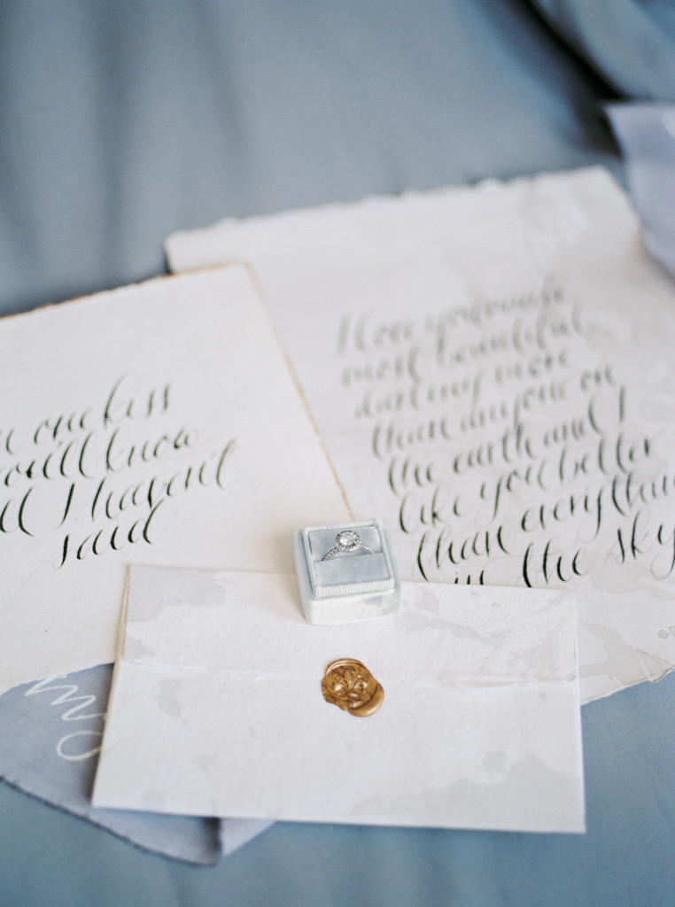 Romantic circle cut diamond ring in a Mrs Box on top of hand-written calligraphy vows from Spurle Gul Studio. Captured by Niagara wedding photographer www.kaylayestal.com