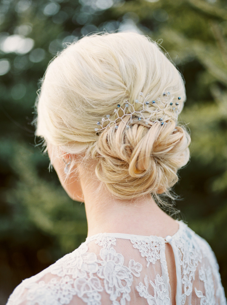 Loose romantic low bun with hair piece from Frilly bits. From a Spring Beamer Falls Manor wedding in the Niagara Region of Canada styled by Danielle of Shaw Events and photographed by fine art wedding photographer Kayla Yestal. Featuring a flowing grey-blue tulle skirt and lace top by Alexandra Grecco, suit by Zara, florals from Niagara florist Cathy Martin Flowers, and hair and makeup by Jillian of Glow. Hair and Beauty. Captured by Niagara wedding photographer www.kaylayestal.com