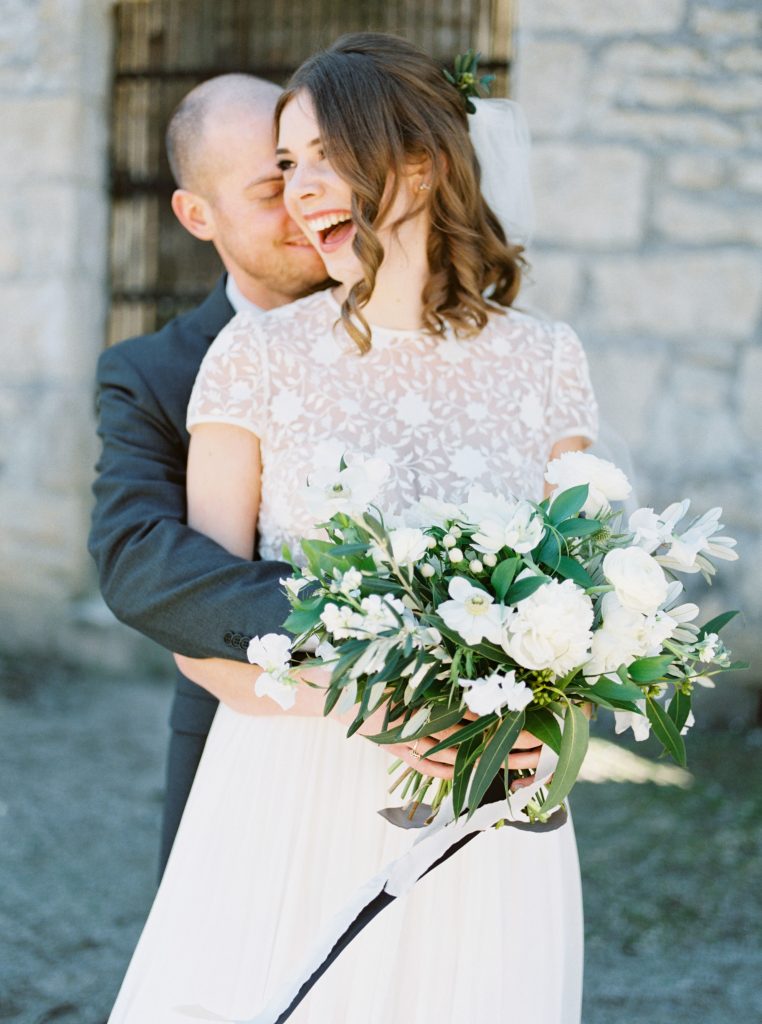 Bride wearing a Tatyana Merenyuk separate wedding gown at Goldie Mill with a Blooms and Flora green and white loose bouquet photographed by Guelph wedding photographer Kayla Yestal | Alton Mill Wedding | Goldie Mill Wedding | Caledon Wedding Photographer