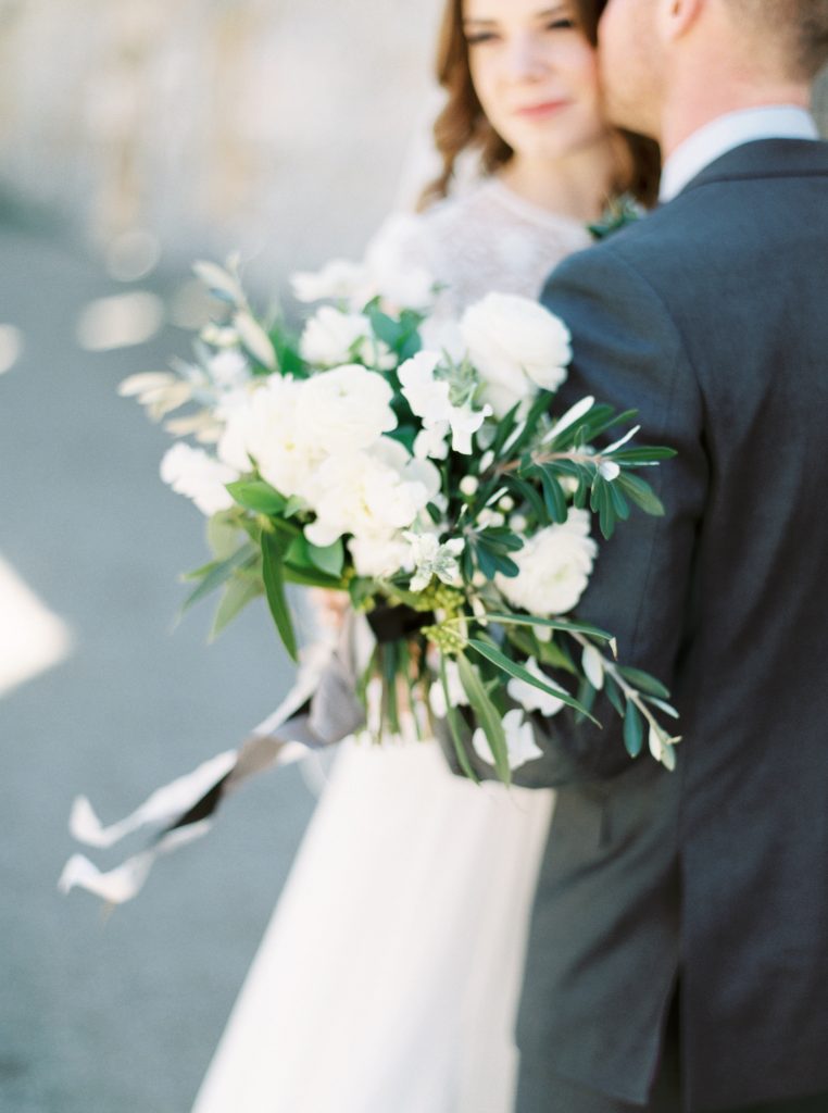 Bride wearing a Tatyana Merenyuk separate wedding gown at Goldie Mill with a Blooms and Flora green and white loose bouquet photographed by Guelph wedding photographer Kayla Yestal | Alton Mill Wedding | Goldie Mill Wedding | Caledon Wedding Photographer