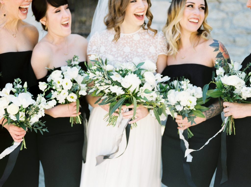 Bridesmaids in black off the shoulder dresses | Blooms and Flora loose green and white bouquets with Froufrou Chic ribbon at Goldie Mill | Alton Mill Wedding | Goldie Mill Wedding | Caledon Wedding Photographer | Guelph Wedding Photographer | Kayla Yestal