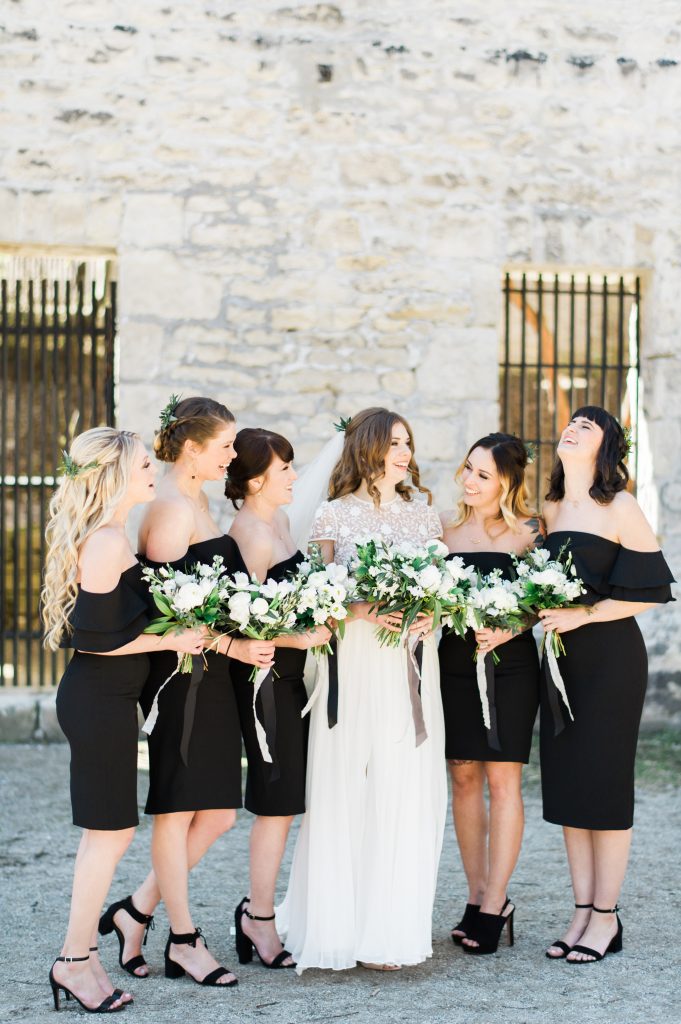 Bridesmaids in black off the shoulder dresses | Blooms and Flora loose green and white bouquets with Froufrou Chic ribbon at Goldie Mill | Alton Mill Wedding | Goldie Mill Wedding | Caledon Wedding Photographer | Guelph Wedding Photographer | Kayla Yestal