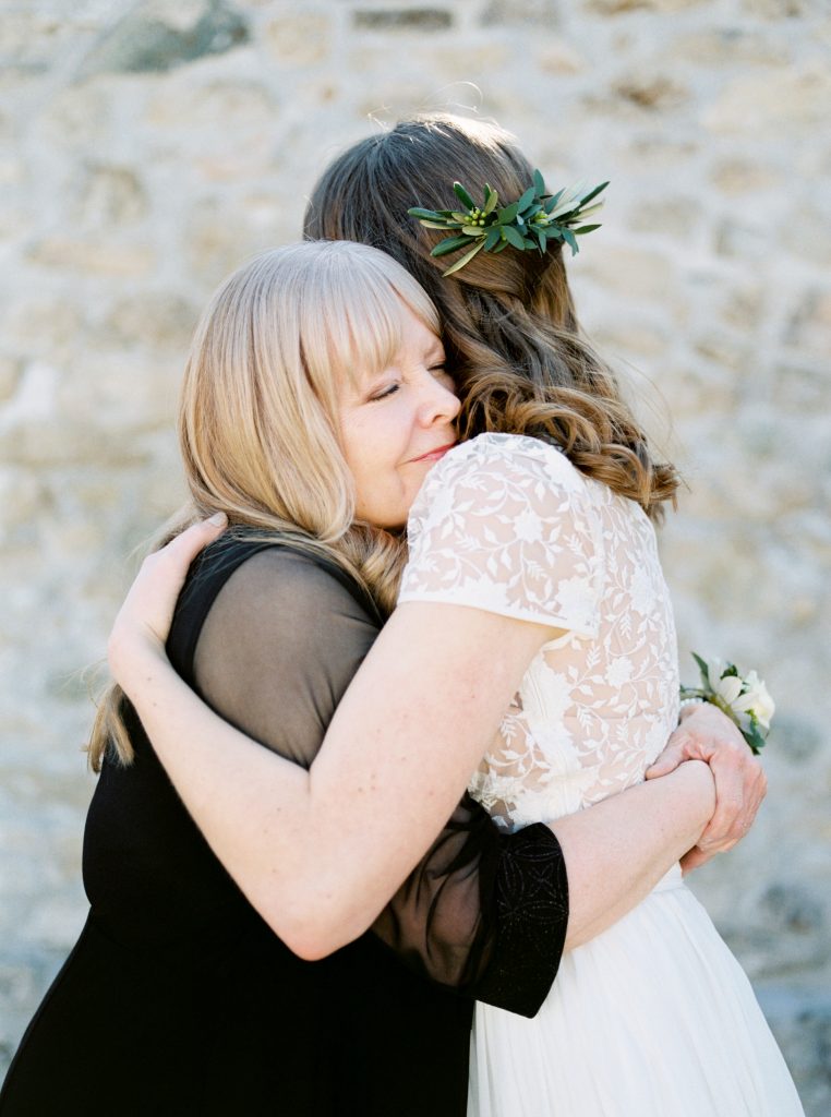 Bride and mother of the bride hugging photo | Bride wearing a Tatyana Merenyuk separate wedding gown at Alton Mill photographed by Guelph wedding photographer Kayla Yestal | Alton Mill Wedding | Goldie Mill Wedding | Caledon Wedding Photographer