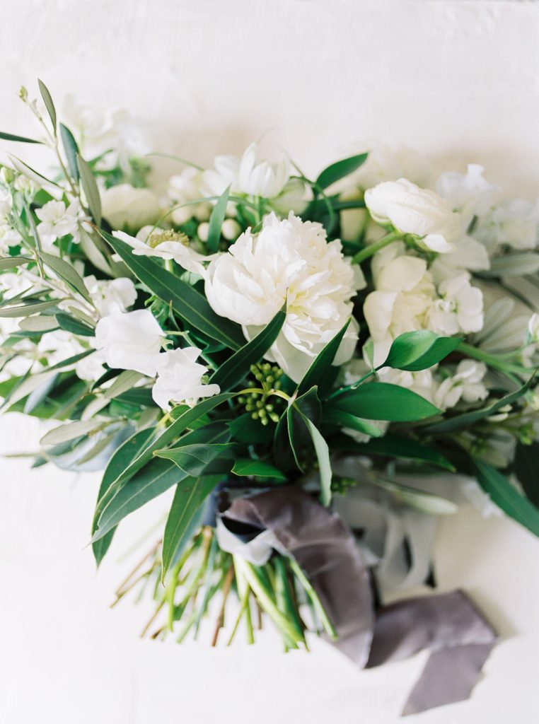 Loose greenery bouquet by Blooms and Flora photographed on a Pilgrim and Co styling board by Emma Natter by Guelph wedding photographer Kayla Yestal | Alton Mill Wedding | Goldie Mill Wedding | Caledon Wedding Photographer | Green and White Bouquet